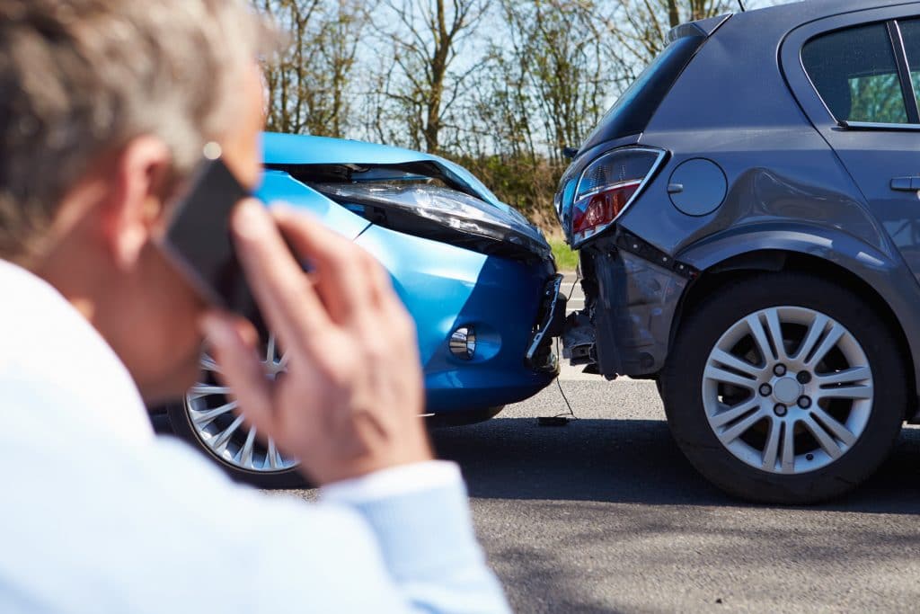 Driver Making Phone Call After Traffic Accident Car Accident Claims in Alabama